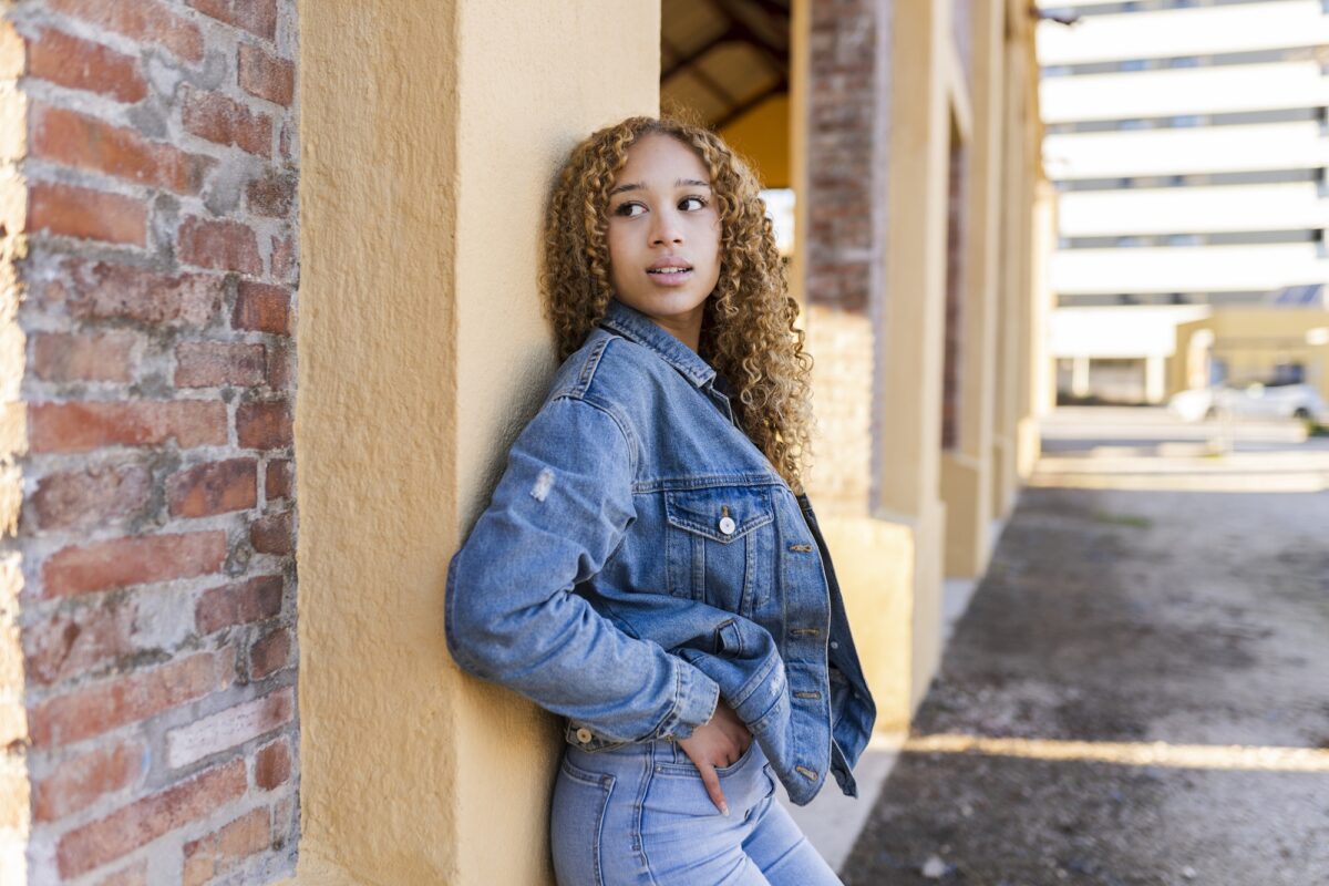 hoping and waiting for someone pretty blonde woman hoping leaning against a wall