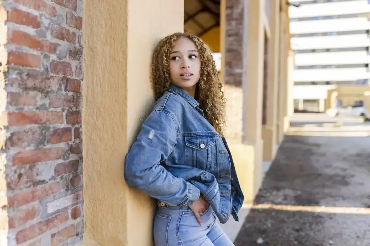 hoping and waiting for someone pretty blonde woman hoping leaning against a wall